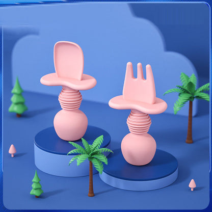 Pink silicone baby spoon and fork set displayed upright