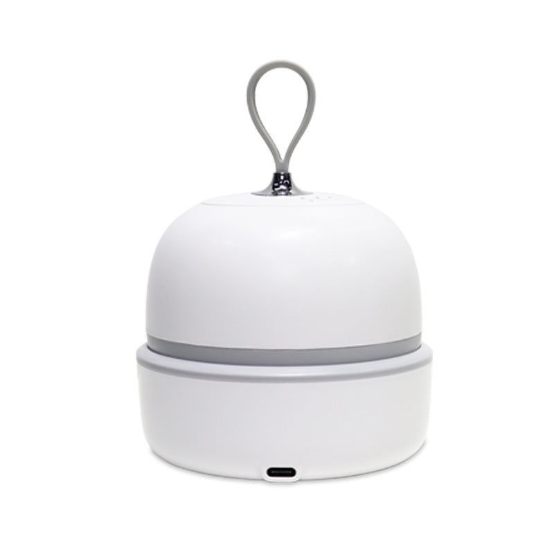 White rechargeable scalp massager resting in its base