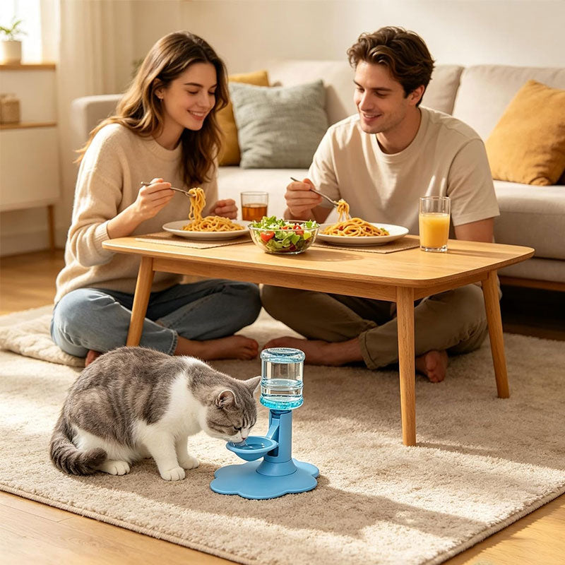 Cat using a blue dispenser beside a seated couple