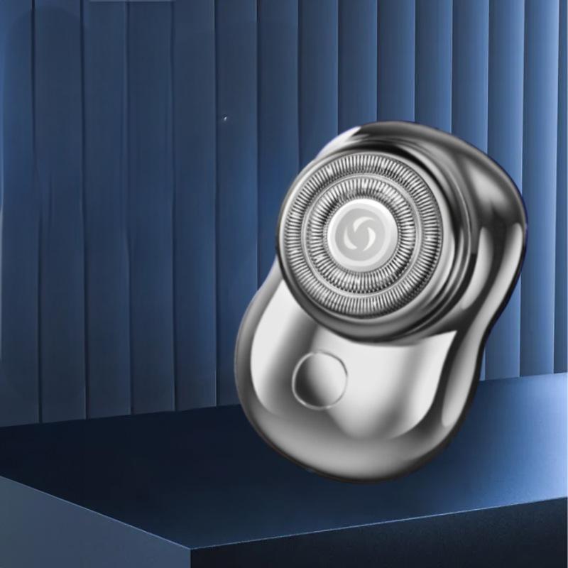 Silver mini rechargeable electric shaver on a platform