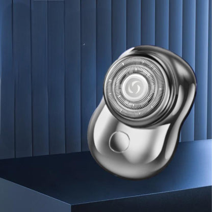 Silver mini rechargeable electric shaver on a platform
