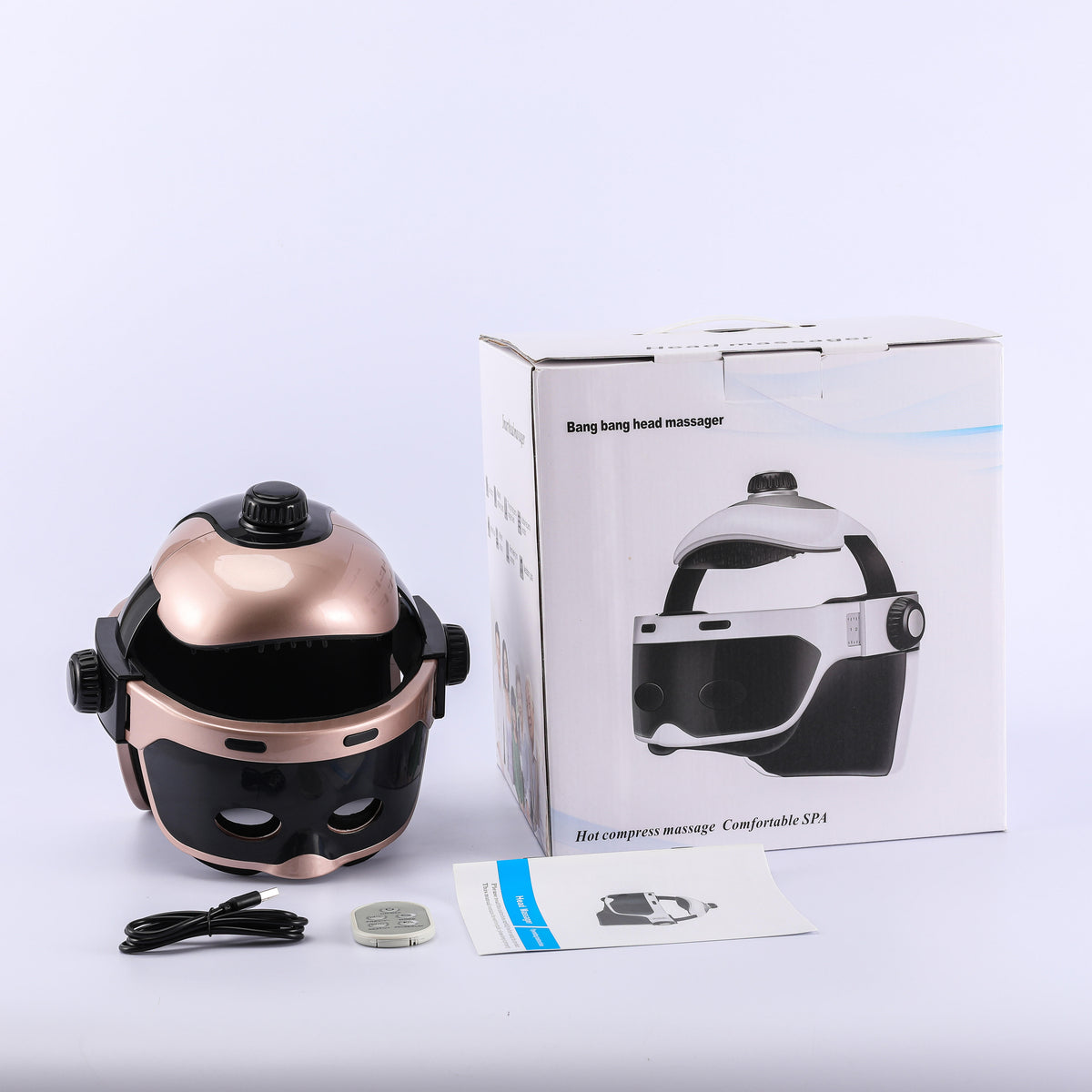 Gold-tone head massager with its pictured box and accessories