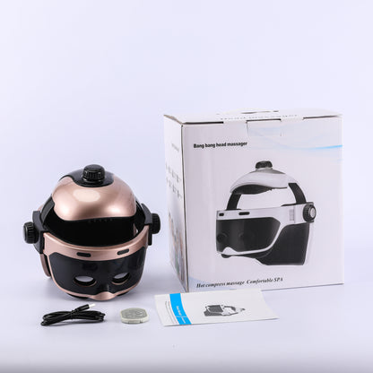 Gold-tone head massager with its pictured box and accessories
