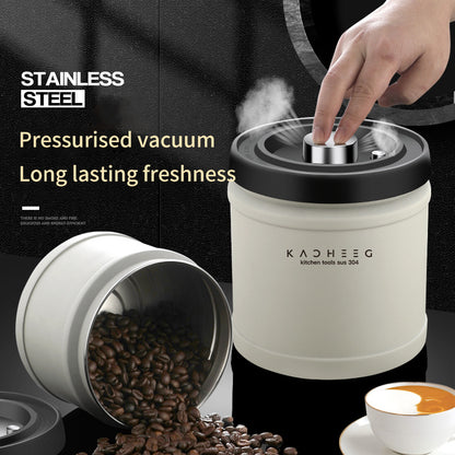 Vacuum storage canister with its lid button being pressed beside coffee beans