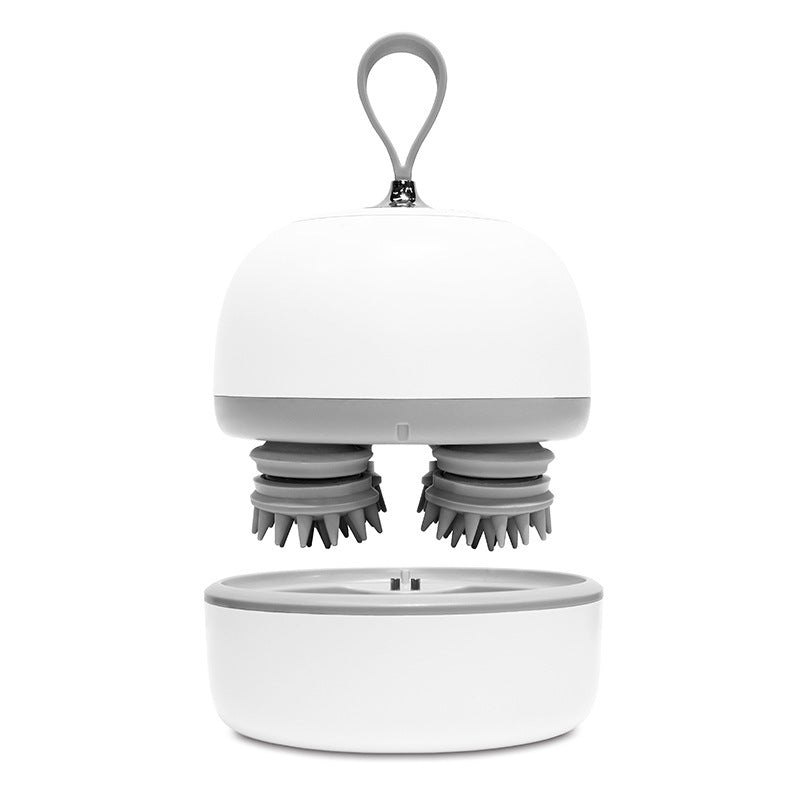 White scalp massager lifted above its base to show the massage heads