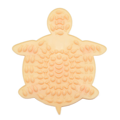 Orange turtle-shaped silicone pet lick mat with textured surface