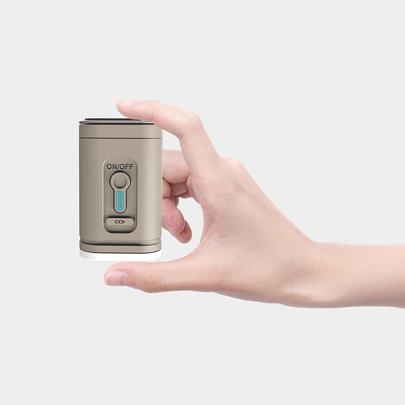 Tan rechargeable air pump held between finger and thumb
