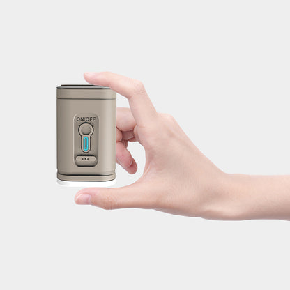 Tan rechargeable air pump held between finger and thumb