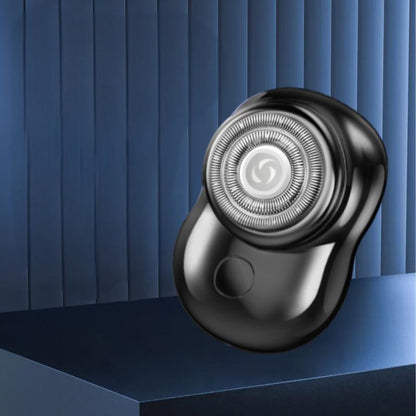 Black mini rechargeable electric shaver on a platform