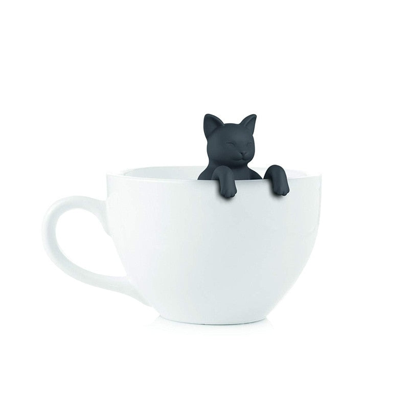Dark cat-shaped infuser hanging over a white mug