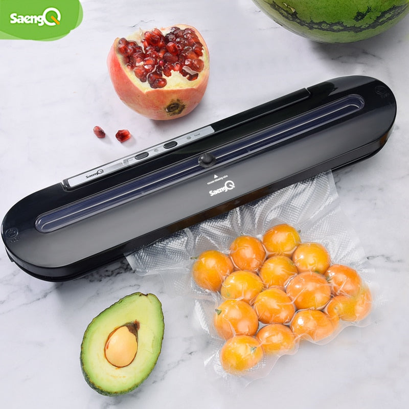 Black food vacuum sealer pictured sealing a bag of fruit
