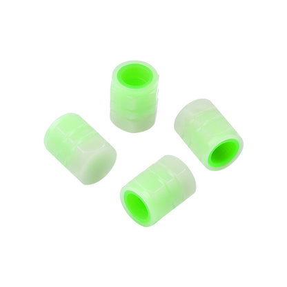 Green tire valve caps showing their threaded openings