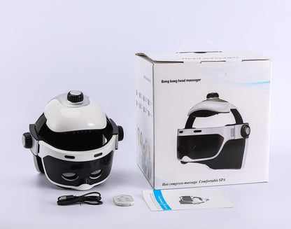 White head massager pictured with packaging, cables and instructions