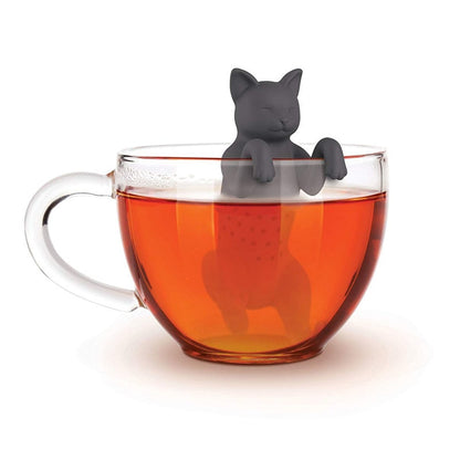 Gray cat-shaped tea infuser hanging over a clear cup of tea