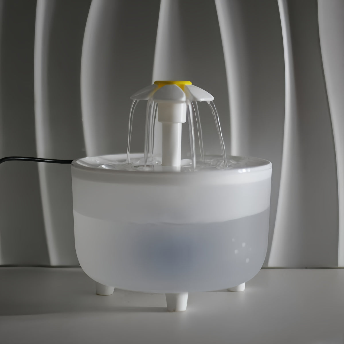 Flower-style pet water fountain shown with water flowing from the outlet