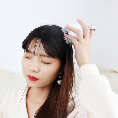 Handheld scalp massager being used near the temple