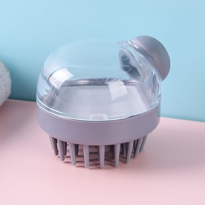 Gray shampoo brush with clear reservoir and round dispenser button