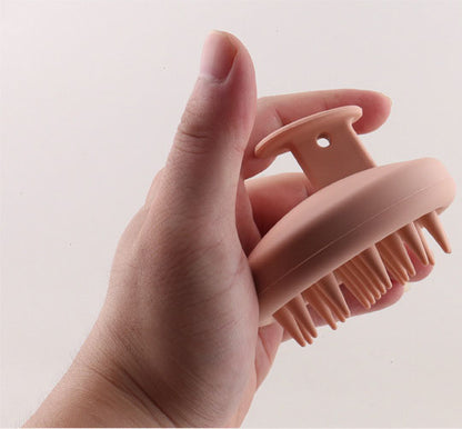 Hand holding the scalp brush by its finger grip