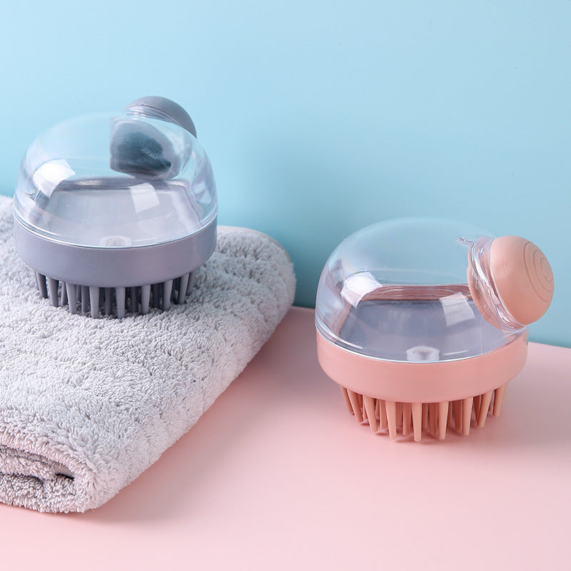 Gray and pink shampoo brushes beside a folded towel