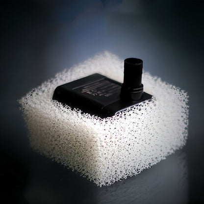 Close-up of a pet fountain pump surrounded by a white filter element