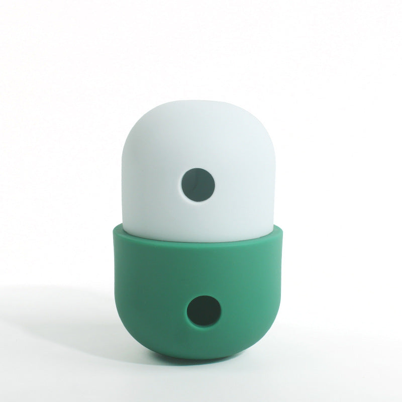 Ivory and dark green treat-dispensing pet toy