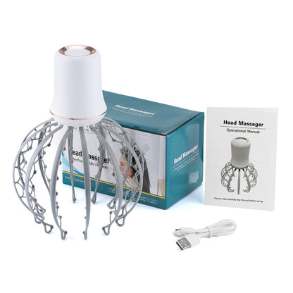 Light gray scalp massager pictured with box, instructions and cable