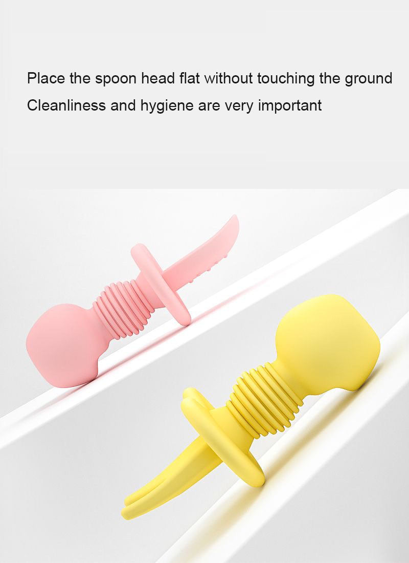 Silicone feeding utensils resting on their handles and guards