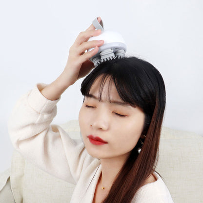 Handheld scalp massager being used on top of the head