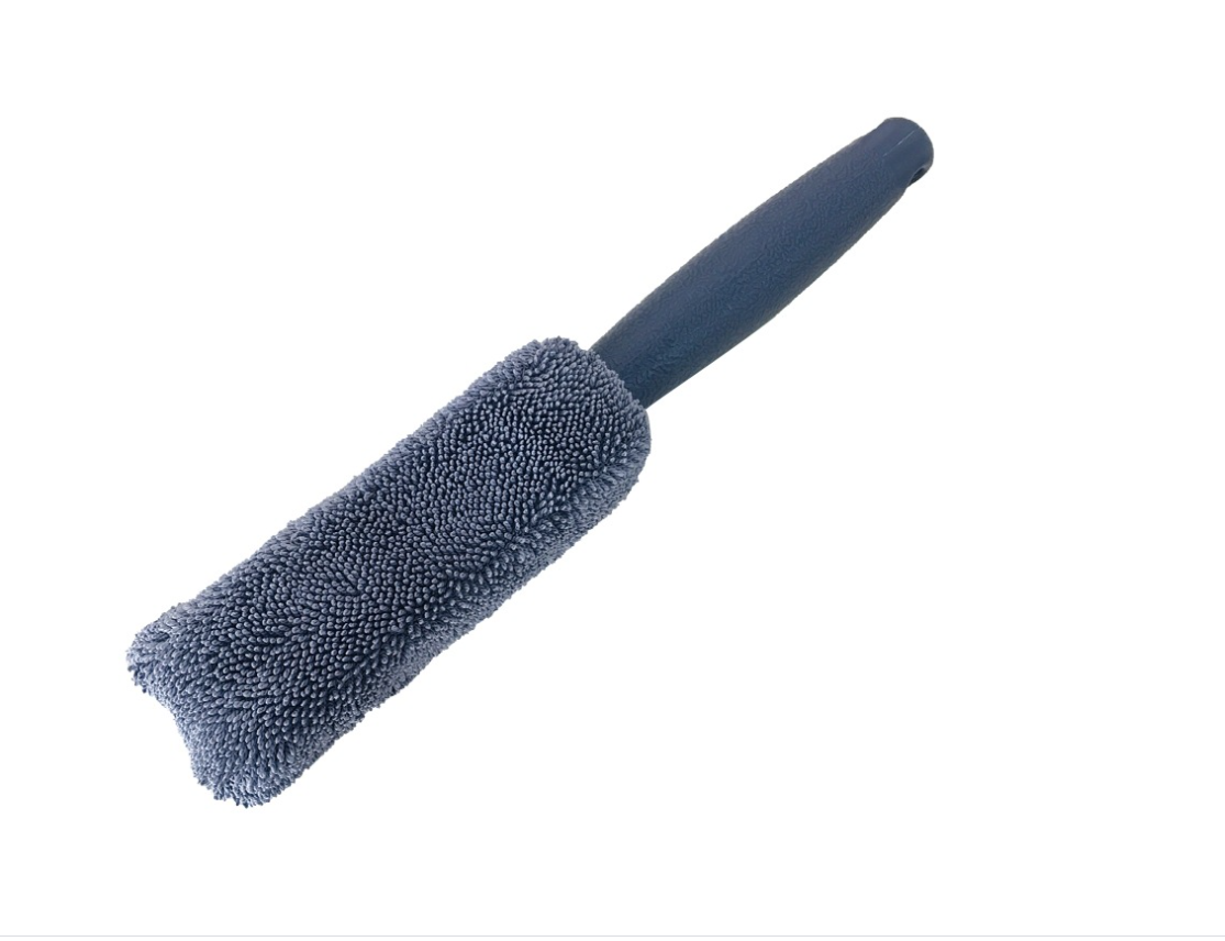 Angled view of the gray microfiber rim brush and black handle