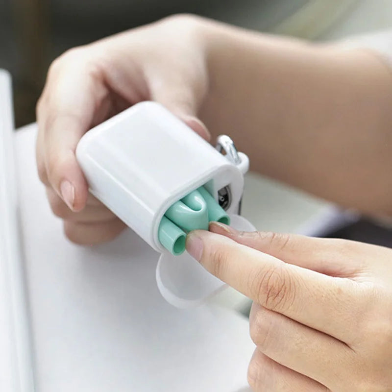 Hands removing a green straw from its carrying case